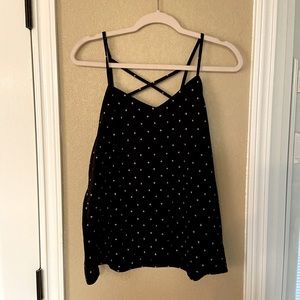 Black criss cross tank with white + on it